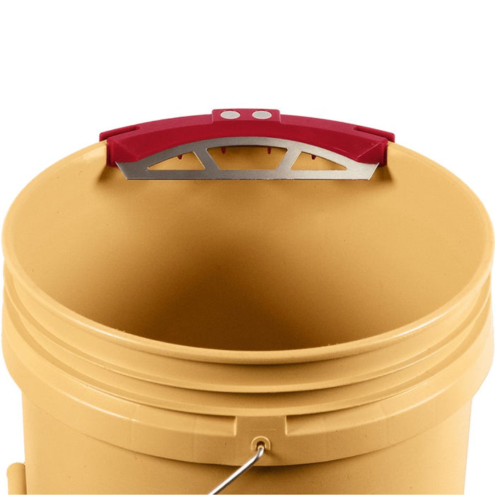 Bucky Scraper top view on a yellow bucket lid, showing red frame and metal blade
