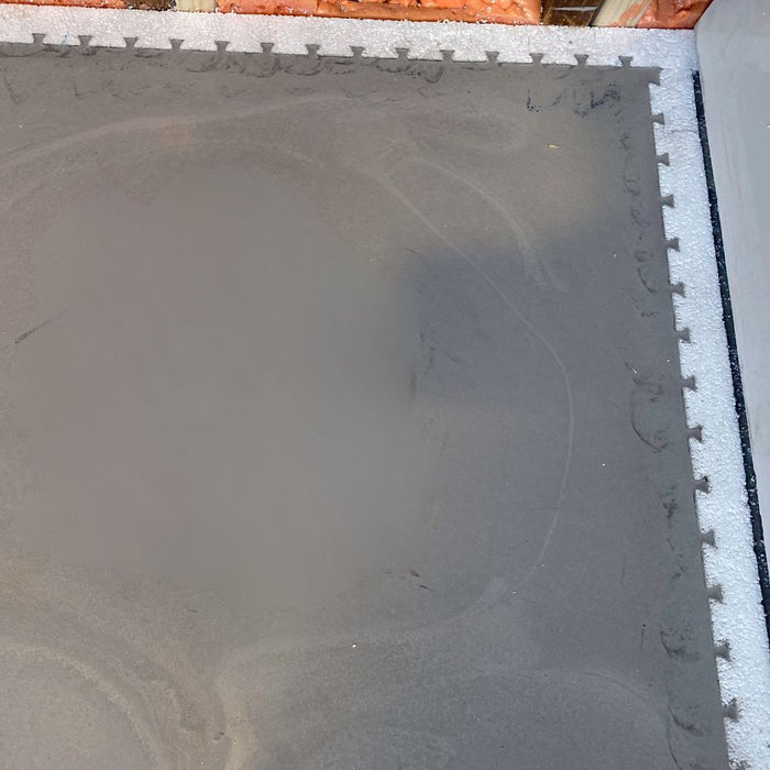 Foam perimeter strip with snap-fit teeth along edge, bordered on dark mat