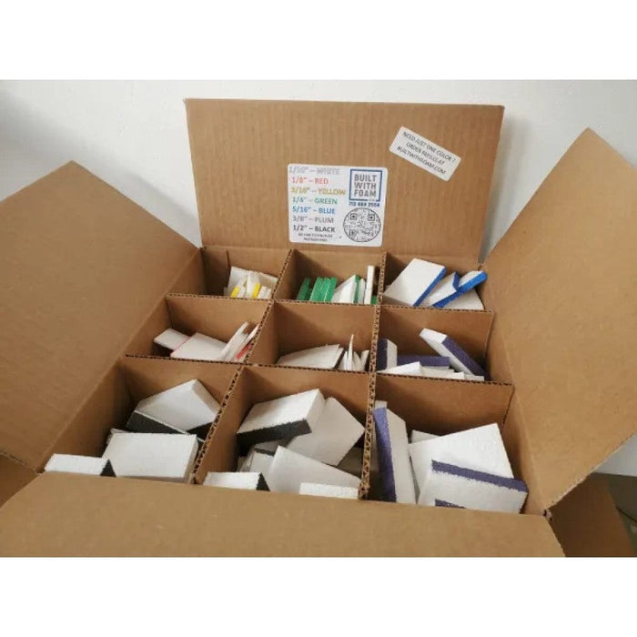 Open box of assorted foam shims and colored spacer strips