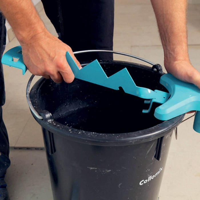 Sharky Bag Ripper tool in a black bucket, teal scraper heads being used