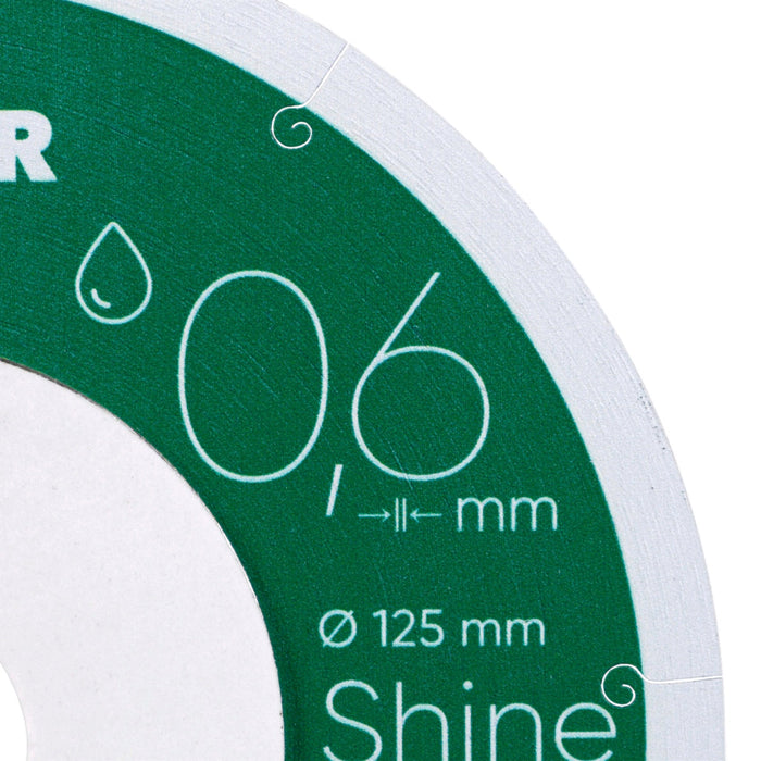 Close-up of a green and white circular object with text and measurements.