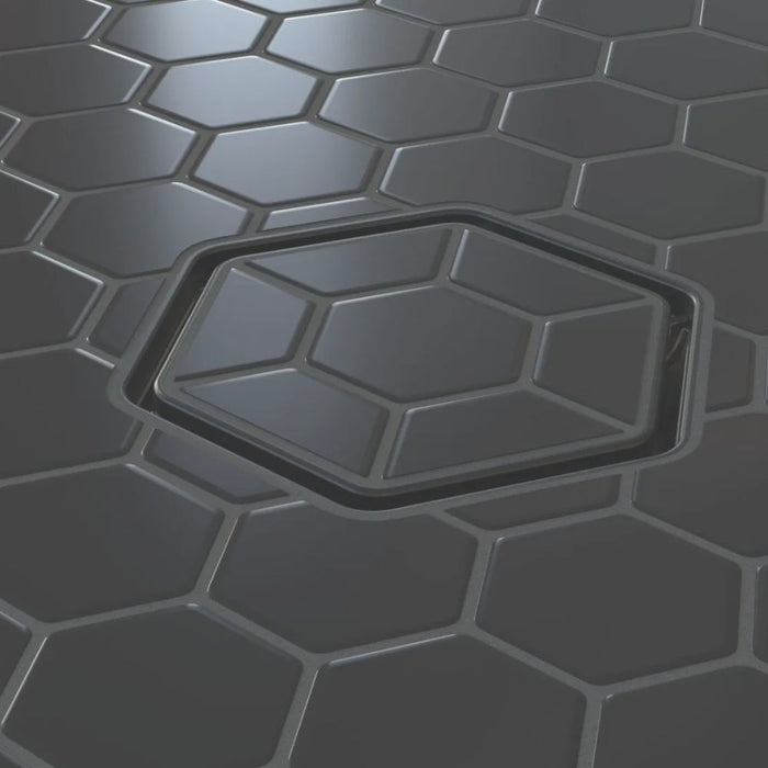 Tile-in hex drain opening with dark insert and brushed metal square frame