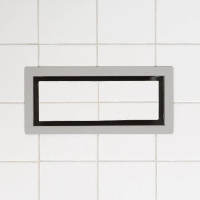 Framed OG floor vent faceplate in dark finish with slim rectangular opening
