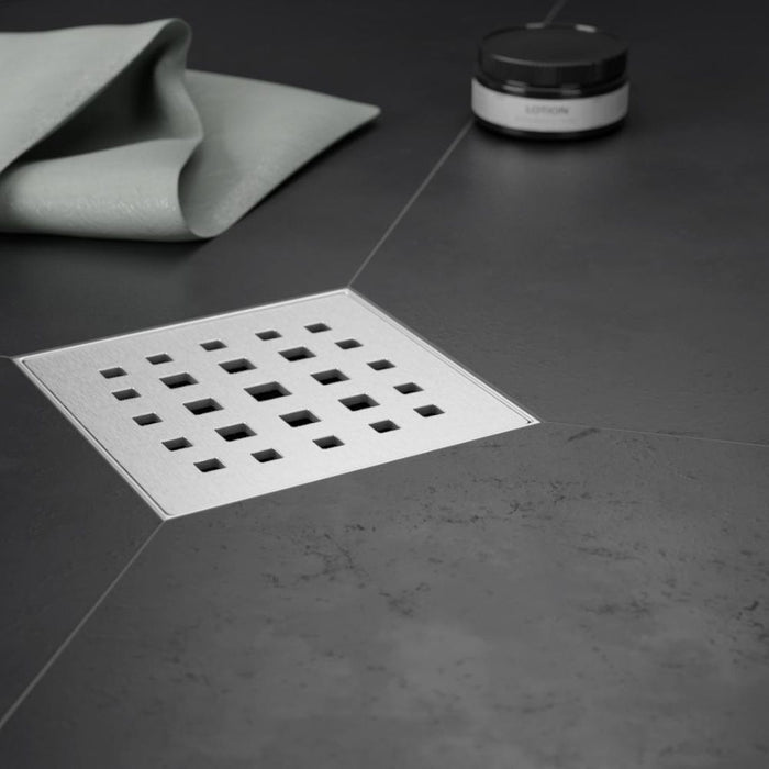Point Drain brushed cover with square grid of drain holes