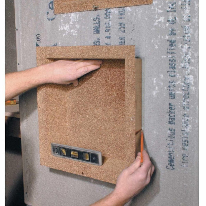 Shower niche insert being positioned into wall opening during installation