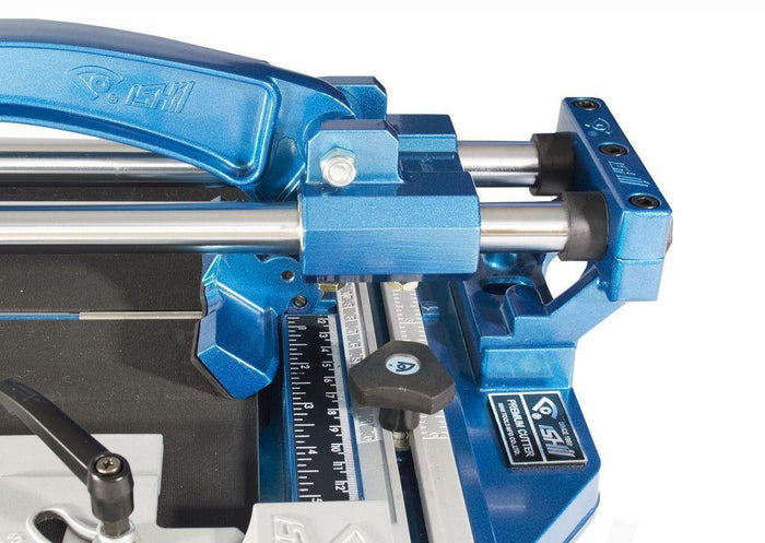 Porcelain tile cutter close-up of steel guide, blue stop, and measurement scale