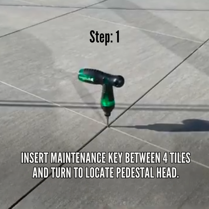 Maintenance adjustment key inserted at tile joint, green driver pointing down