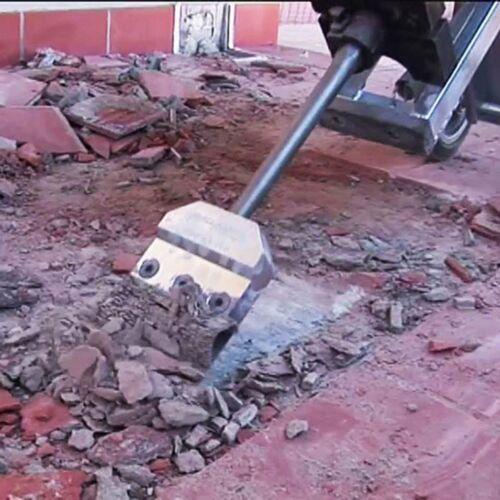 Heavy-duty replacement blade on tiling stripper head during use