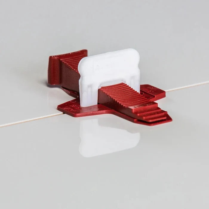 Red tile leveling base with white wedge insert and raised ridges