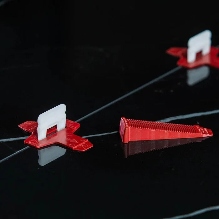Red and white tile leveling bases on leveling rods, T-lock clip style