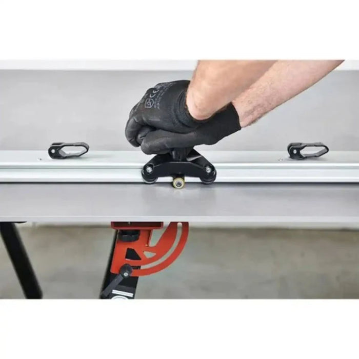 Hand positioning the black cutting head on the metal guide rail