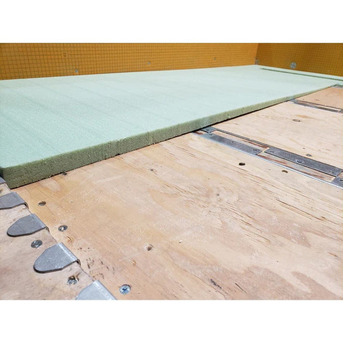 Light green foam filler pad along the edge near the floor drain fitting
