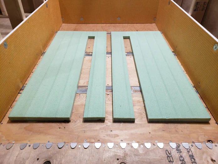 Foam filler boards arranged with center gap for a floor drain opening