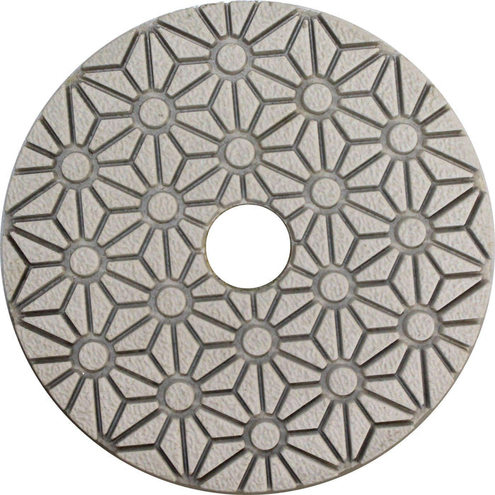 Hybrid polishing pad backing with geometric pattern and central mounting hole