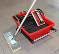 Red grout bucket with pedal roller and metal frame, perforated base platform