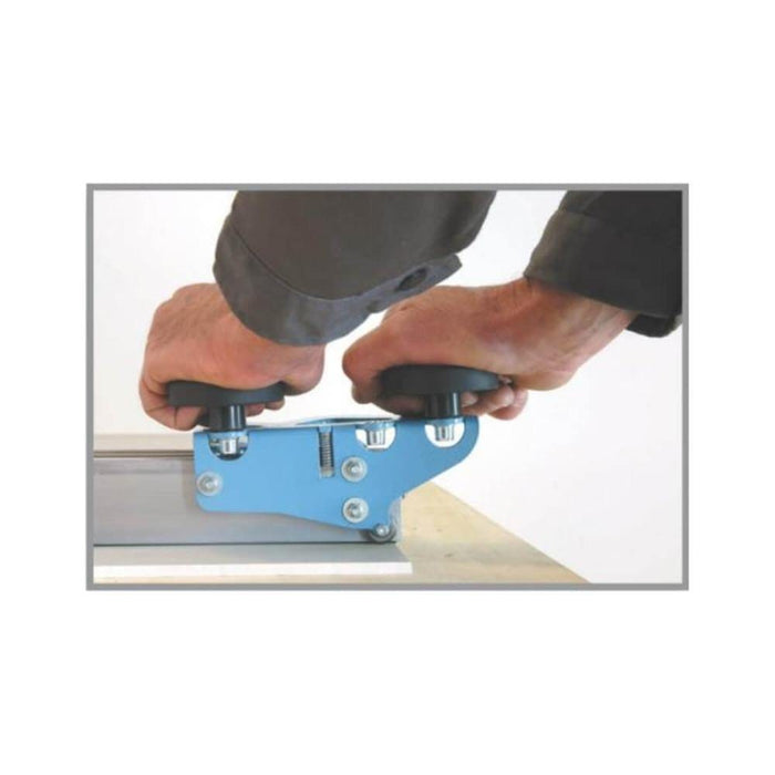 Thin panel tile cutter in use: blue handle cutting on metal rail