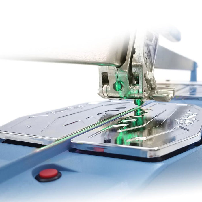 Needle area with green laser line and presser foot on blue sewing machine