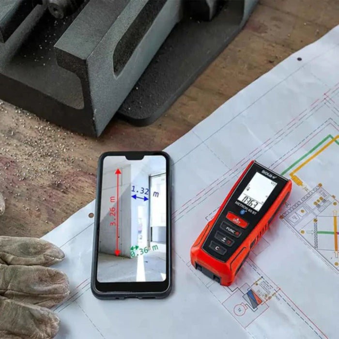 Laser distance meter next to phone displaying measurements and distance diagram
