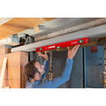 Red spirit level with green vials for checking alignment during installation work