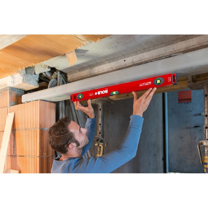 Sola X PRO spirit level placed on a ledge under construction beams