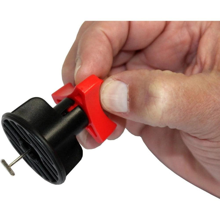 Hand tightening red-and-black tile leveling wedge with metal rod