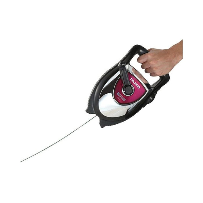Hand holding chalk line tool; chalk line extends from the reel