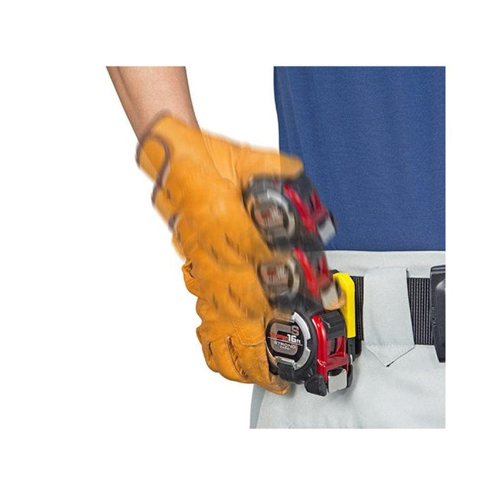 Tape measure with extendable metal band, worn on the tool belt in gloved hand